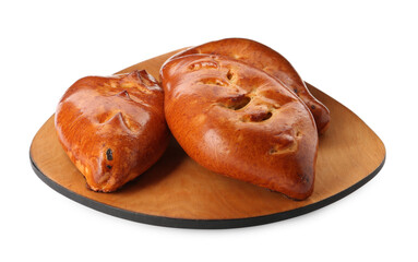 Wooden board with delicious baked patties on white background