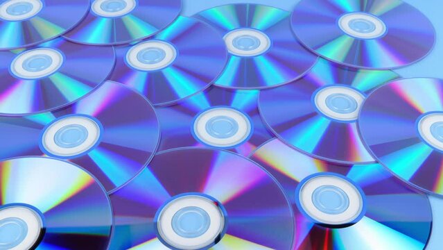 Several CDs are laid out on a horizontal surface with the recordable side up