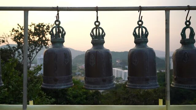 metallic bells hanging in a row outside in thai buddhist temple, Thai temple bell which believe that who knock this bell will get the good luck