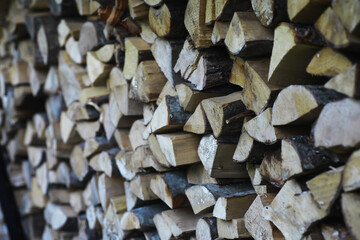 Firewood in a pallet. Chopped firewood lies on the ground. Wooden background..