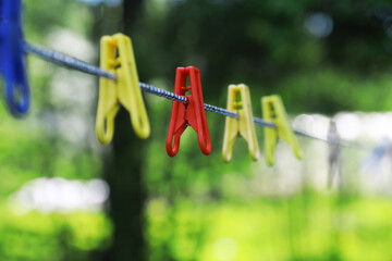 Clothespins on a clothesline in summer. Dry clothes outside. Clothes on a rope.