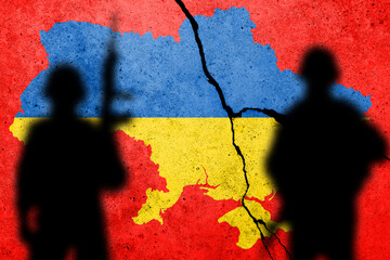 Flag of Ukraine painted on a concrete wall with soldiers. Relationship between Ukraine and Russia