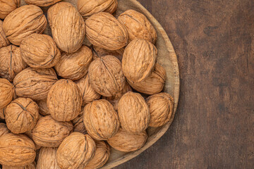 Walnuts on dark vintage table. Walnuts kernels  top view, copy space.