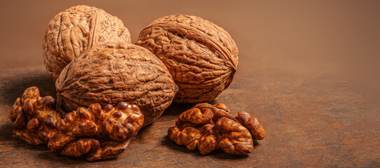 Walnuts on dark vintage table. Walnuts kernels  top view, copy space.