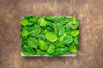  Spinach leaves on wooden  background. Fresh Spinach Closeup. Top view.Copyspace.
