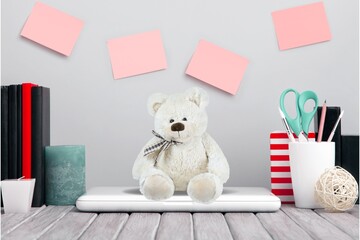 A laptop at children's workplace with toy bear. Back to school online learning concept