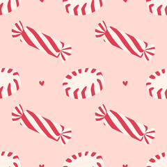 Sweet candy seamless pattern with decorative hearts on pastel pink background. Vector red and white candy and hearts, for background and print on textiles.