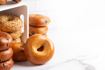Stacks of Various Flavors of Bagels on a Counter