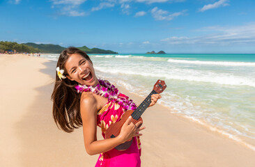 Hawaiian ukulele funny woman having fun singing loud and dancing while playing guitar on Hawaii...
