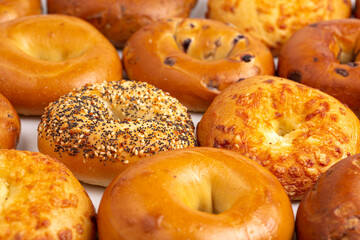 A Variety of Different Bagel Flavors on a White Background