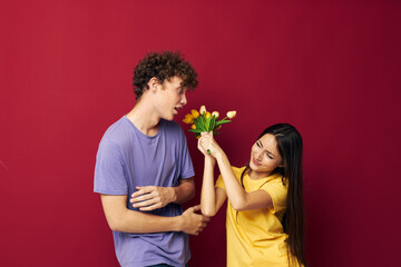 cute young couple gift bouquet of flowers fun isolated background unaltered