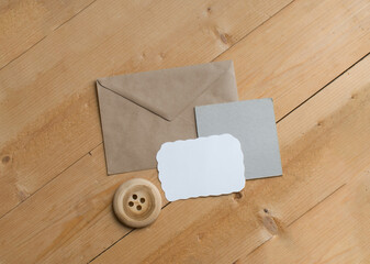 A white and gray empty mockup of a postcard, a letterhead, a kraft paper envelope and a large...