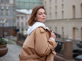 Fototapeta premium Beautiful woman walk in autumn cloudy Moscow. Street style. Travel to Russia concept.