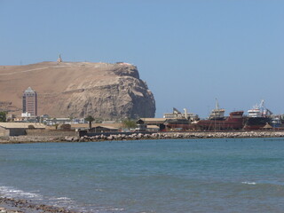 Photograph taken on a sunny day around Arica City at Chili, showing the architecture and colours of this historical place. Streets, beach, cemetery, desert, houses, square.