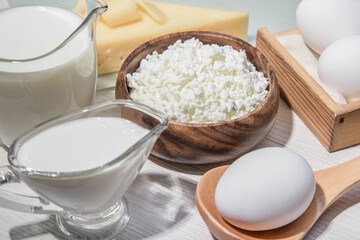 Fototapeta na wymiar Food is a source of calcium, magnesium, protein, fats, carbohydrates, balanced diet. Dairy products on the table: cottage cheese, sour cream, milk, cheese, chicken egg, contain casein, albumin