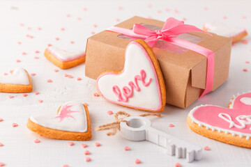 Cardboard box with ribbon and sweet handmade heart-shaped cookies present for wedding or Valentine day.