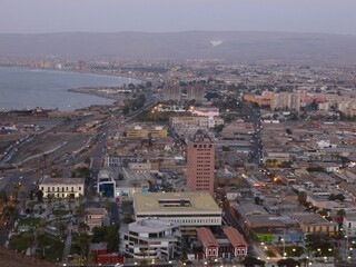Photograph taken on a sunny day around Arica City at Chili, showing the architecture and colours of this historical place. Streets, beach, cemetery, desert, houses, square.