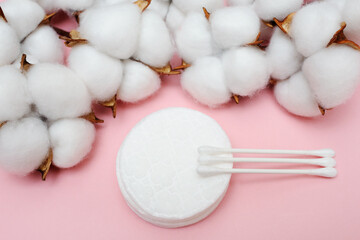 Cotton pads and makeup sticks close-up. Pink background. Beauty and makeup blog