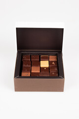 Assortment small milk black milk square artisanal chocolate candies in little gift box