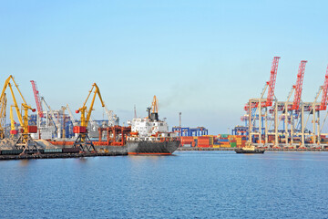 Tugboat assisting general cargo ship