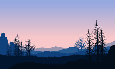 A beautiful mountain view at dusk from the edge of the village with the silhouettes of dry trees around