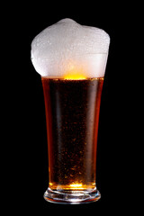 Wet Glass of dark beer isolated on black background.