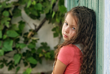 Fototapeta premium Portrait of a pensive little girl.