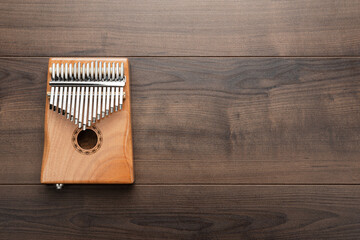 Wooden kalimba on the wooden background. Overhead photo of mbira instrument with copy space.