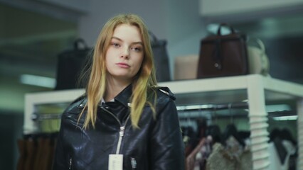 Obraz na płótnie Canvas A pretty girl tries on clothes in a clothing store. Shopping