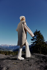 young woman standing on the top of the mountain forest relaxation