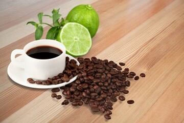 Lemon black coffee in cup, coffee beans, lemon slices