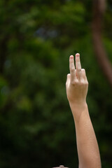 player putting up two fingers as referee for American football game