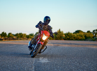 Student riding on motordrome in motorcycle school