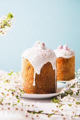 Easter cake with glace icing and decoration. Postcard with Easter bread. Christian traditions. Copy space. White background.
