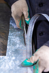 Professional Fitter Hands with Specially Designed Metal Scissors for Metal Sheet Cutting and Operation and Making Adjustments in Workshop.