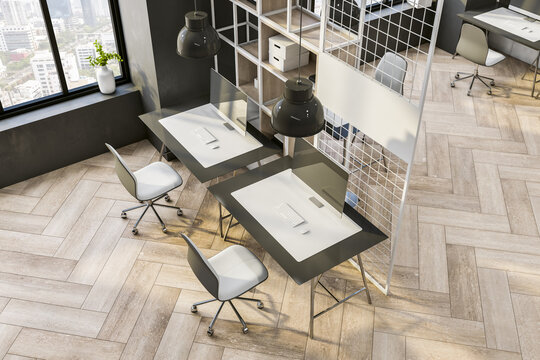 Top view on modern workspaces in sunny spacious office background with black and white tables, chairs, rack and metallic cell partition on wooden floor. 3D rendering