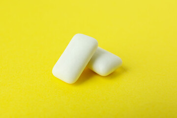 Chewing or bubble gum on yellow background, close up