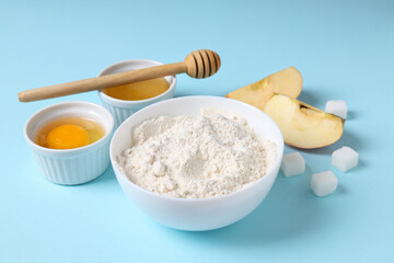 Ingredients for pie or cake cooking on blue background