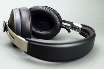 Fototapeta na wymiar Wireless headphones with leather ear pads on a gray background