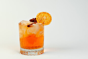 Orange cocktail on a white background. Alcoholic drink with ice close up. Copy space and wine place for text near the glass.