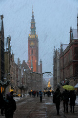 Fototapeta na wymiar City Hall in Gdansk and winter snow-covered historic street
