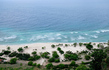Beautiful view of Cristo Rei Backside Beach or known as Dolok Oan Beach in Dili, Timor Leste. Sea waves background. Aerial view of tropical beach.