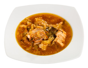 Soup of cabbage with boiled vegetables and pork broth, served in bowl. Isolated over white background