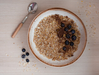 cereal porridge with blueberries and chocolate for breakfast