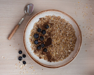 cereal porridge with blueberries and chocolate for breakfast