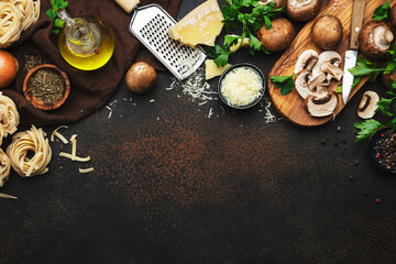 Obraz na płótnie Canvas Italian uncooked pasta, brown champignons mushrooms, vegetables, cheese and ingredients for tasty cooking on old kitchen table background, dark style, top view. Food banner