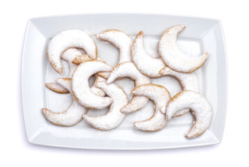 Traditional German or Austrian Vanillekipferl vanilla kipferl cookies on a plate isolated on white background