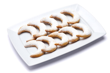 Traditional German or Austrian Vanillekipferl vanilla kipferl cookies on a plate isolated on white background