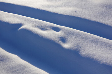 Winter background. Snow and bumps. Snow-covered track