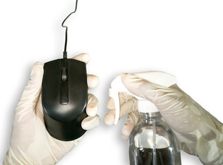 Close up. Hands wearing white gloves, holding a mouse (computer) and alcohol spray. Cleaning to...
